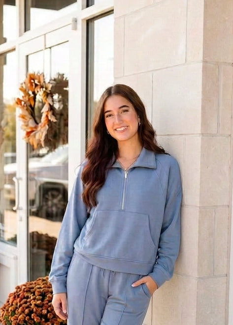 Hyfve half-zip collar raglan pullover in a soft, cozy fabric, featuring a front half-zip and contrasting raglan sleeves.