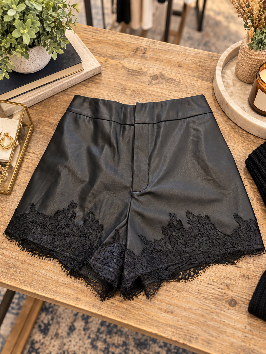 Black faux leather lace trim shorts by Mable, featuring a stylish design with lace detail and a comfortable fit.