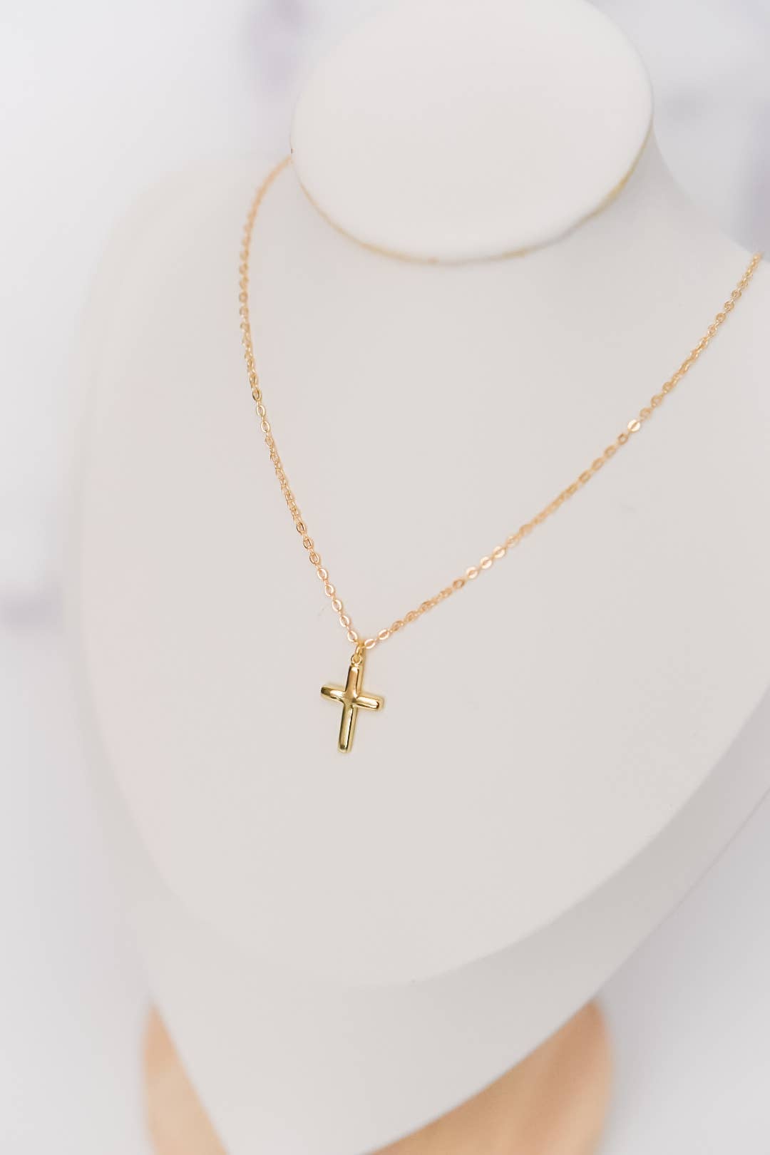 Gold-plated cross necklace by Bella Rey Jewelry featuring a delicate pendant on a fine chain.
