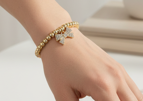 Gold Beaded Bracelet W/ Rhinestone Bow Charm
